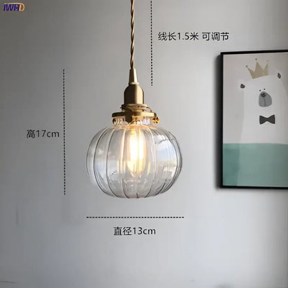 Teal glass ball pendant light with brass hardware for bedroom