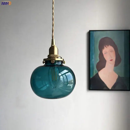 Teal glass ball pendant light with brass hardware for bedroom