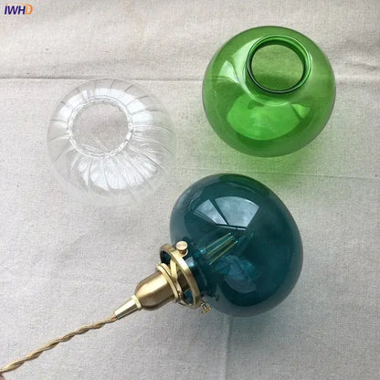 Teal glass ball pendant light with brass hardware for bedroom