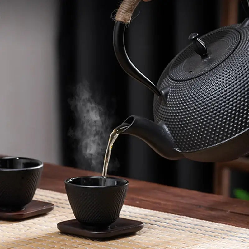Textured black cast iron tea pot with infuser kitchen steeper