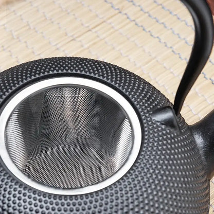 Textured black cast iron tea pot with infuser kitchen steeper