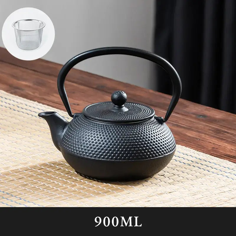 Textured black cast iron tea pot with infuser kitchen steeper