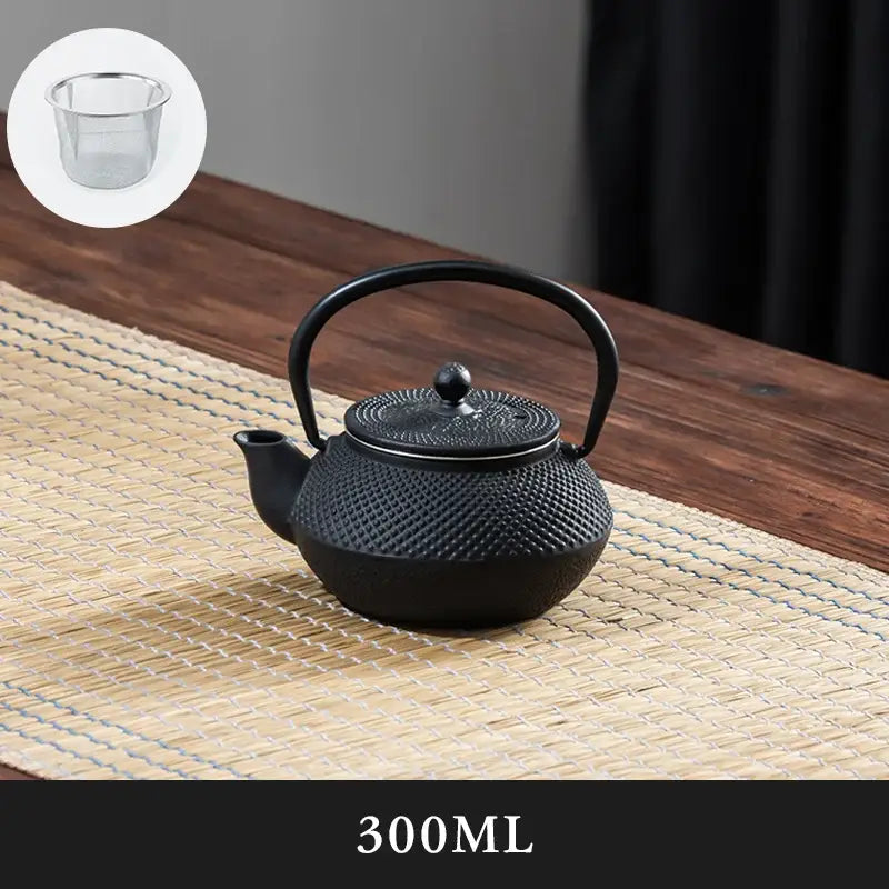 Textured black cast iron tea pot with infuser kitchen steeper