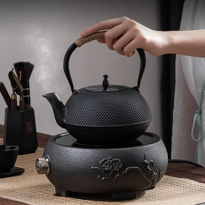 Textured black cast iron tea pot with infuser kitchen steeper