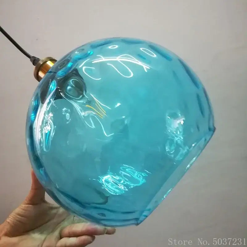 Textured blue glass ball pendant light for dining room