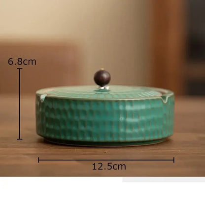 Textured green ceramic ashtray with wooden lid for office or living room
