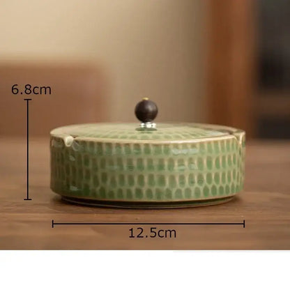Textured green ceramic ashtray with wooden lid for office or living room