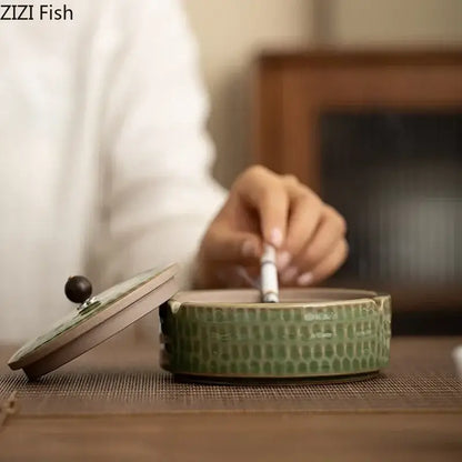 Textured green ceramic ashtray with wooden lid for office or living room