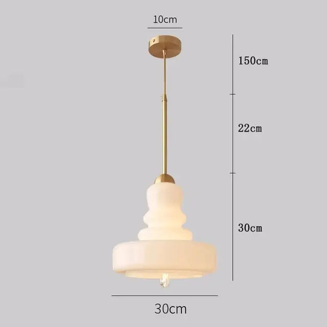 Tiered yellow glass pendant lights with brass accents for kitchens