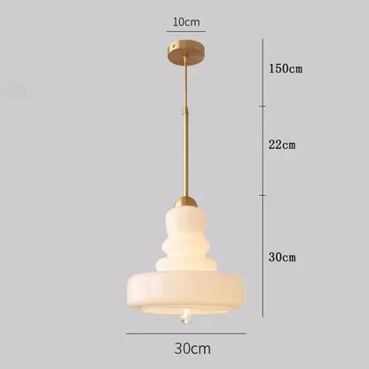 Tiered yellow glass pendant lights with brass accents for kitchens