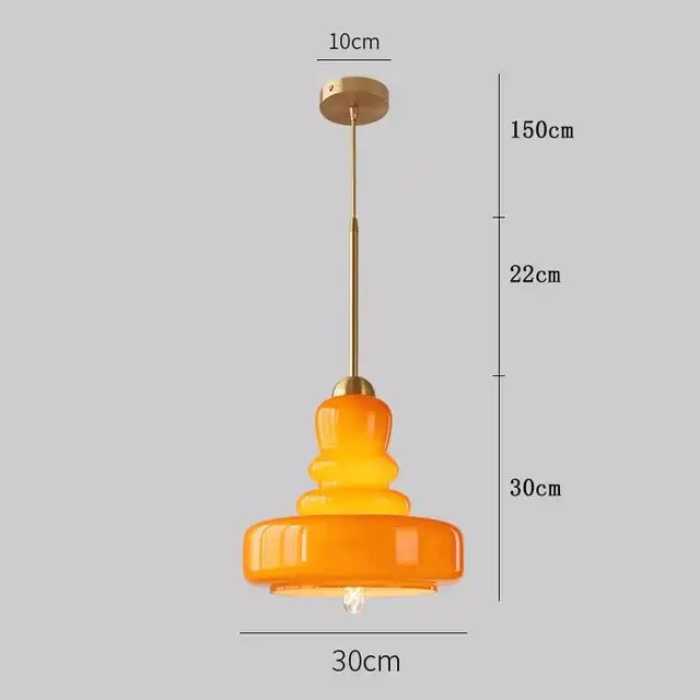 Tiered yellow glass pendant lights with brass accents for kitchens
