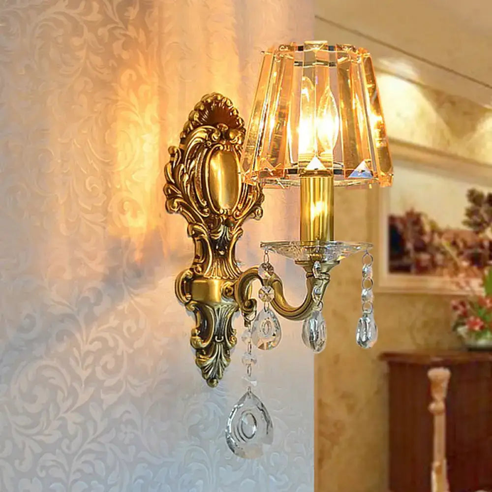 Traditional brass wall lamp with clear crystal shade living room
