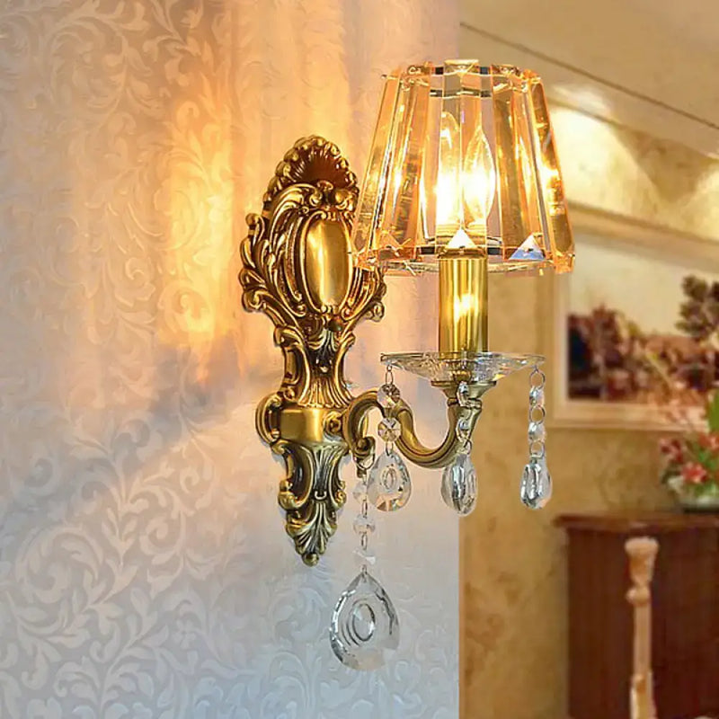 Traditional brass wall lamp with clear crystal shade living room