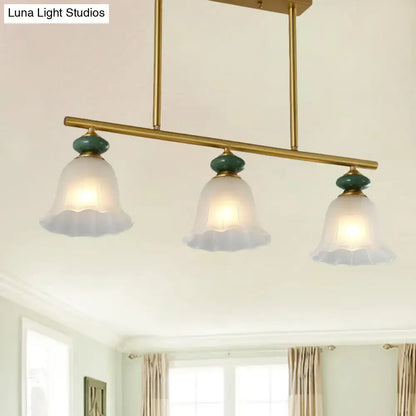 Traditional gold & teal kitchen island light with cream glass shades