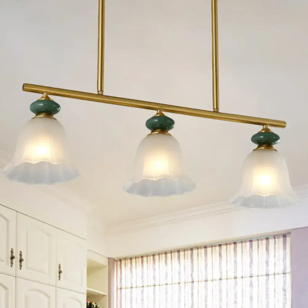 Traditional gold & teal kitchen island light with cream glass shades