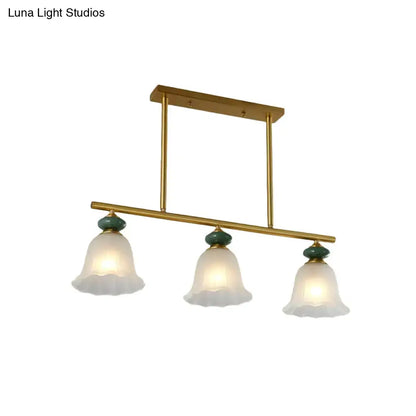 Traditional gold & teal kitchen island light with cream glass shades