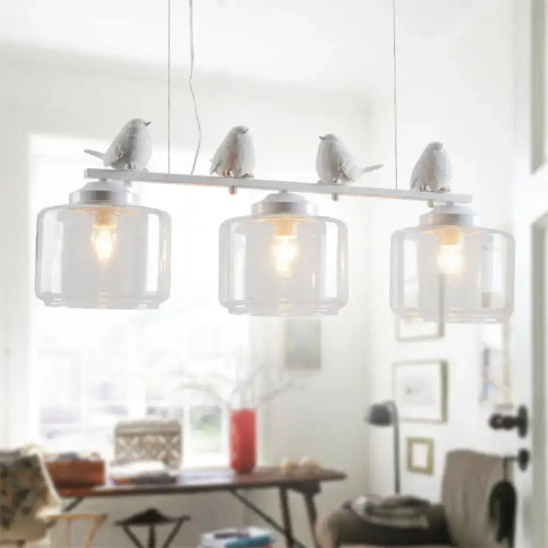 Traditional white ceramic bird and clear glass pendant dining room