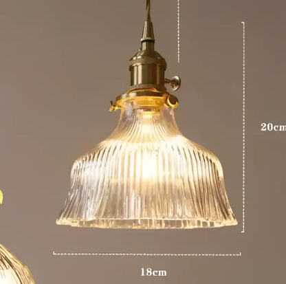 Translucent blue glass pendant light with brass fixture for dining room