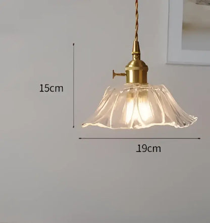 Translucent blue glass pendant light with brass fixture for dining room