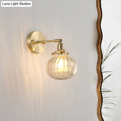 Vintage brass wall light with champagne & clear glass shade bedroom