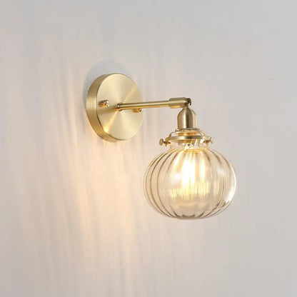 Vintage brass wall light with champagne & clear glass shade bedroom