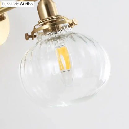 Vintage brass wall light with champagne & clear glass shade bedroom