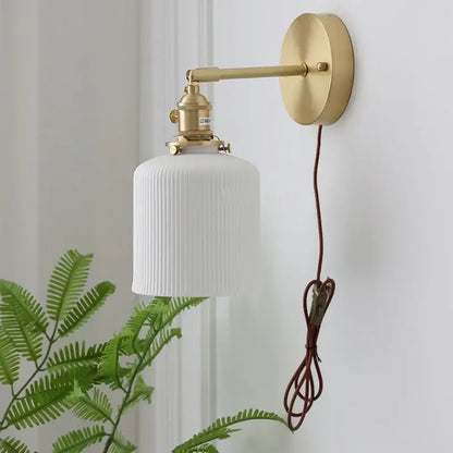 Vintage brass wall light with ribbed glass and knob switch bedroom