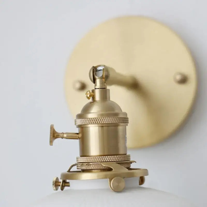 Vintage brass wall light with ribbed glass and knob switch bedroom