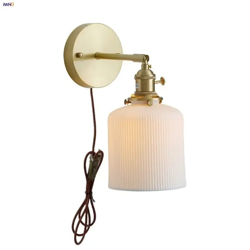 Vintage brass wall light with ribbed glass and knob switch bedroom