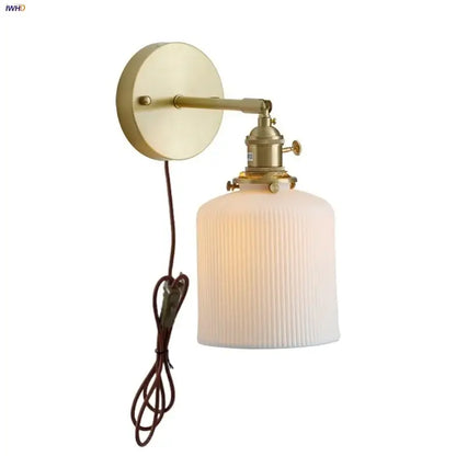 Vintage brass wall light with ribbed glass and knob switch bedroom