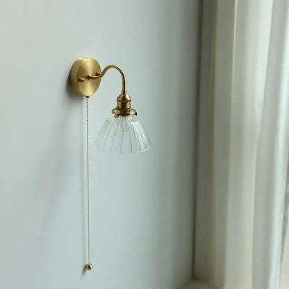 Vintage brass wall sconce with scalloped clear glass for stairways