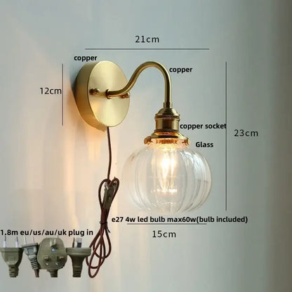 Vintage brass wall sconce with scalloped clear glass for stairways