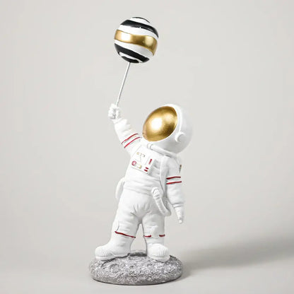 White and gold astronauts figurines with balloons living room decor