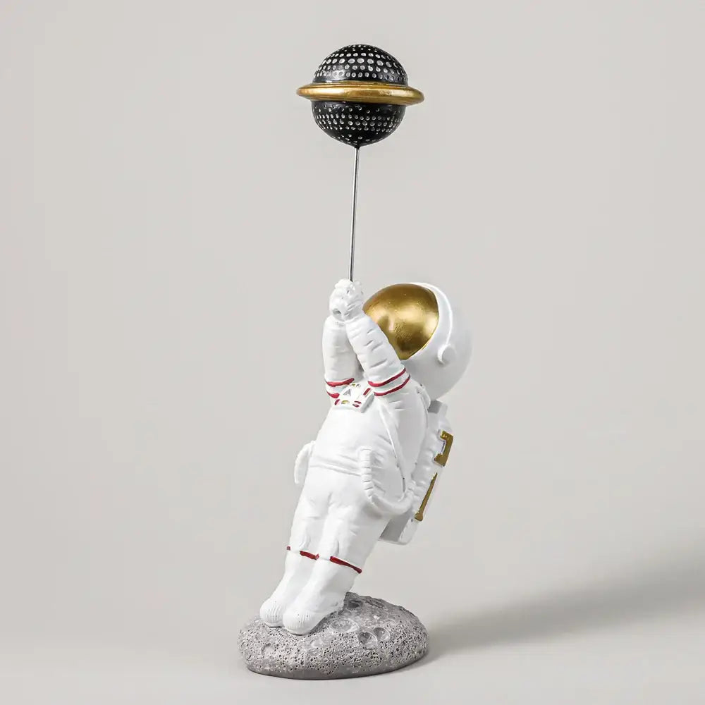 White and gold astronauts figurines with balloons living room decor