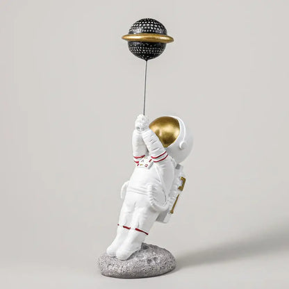 White and gold astronauts figurines with balloons living room decor