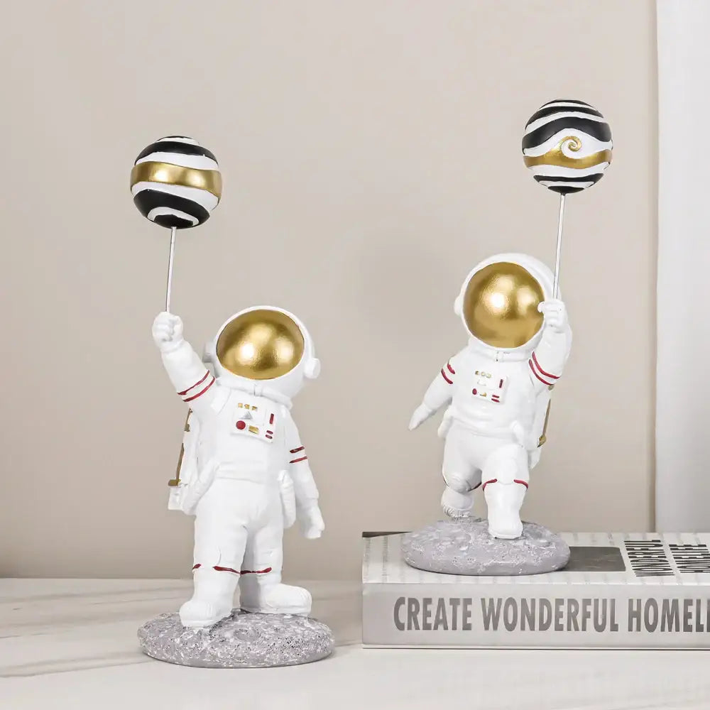 White and gold astronauts figurines with balloons living room decor