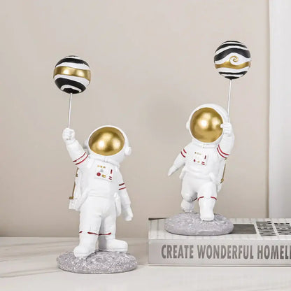 White and gold astronauts figurines with balloons living room decor