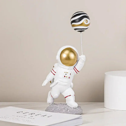 White and gold astronauts figurines with balloons living room decor