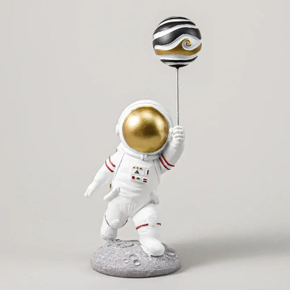 White and gold astronauts figurines with balloons living room decor