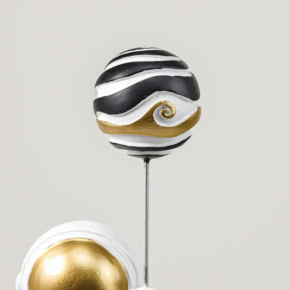 White and gold astronauts figurines with balloons living room decor