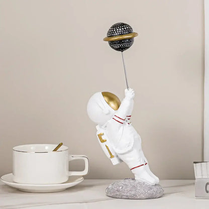 White and gold astronauts figurines with balloons living room decor