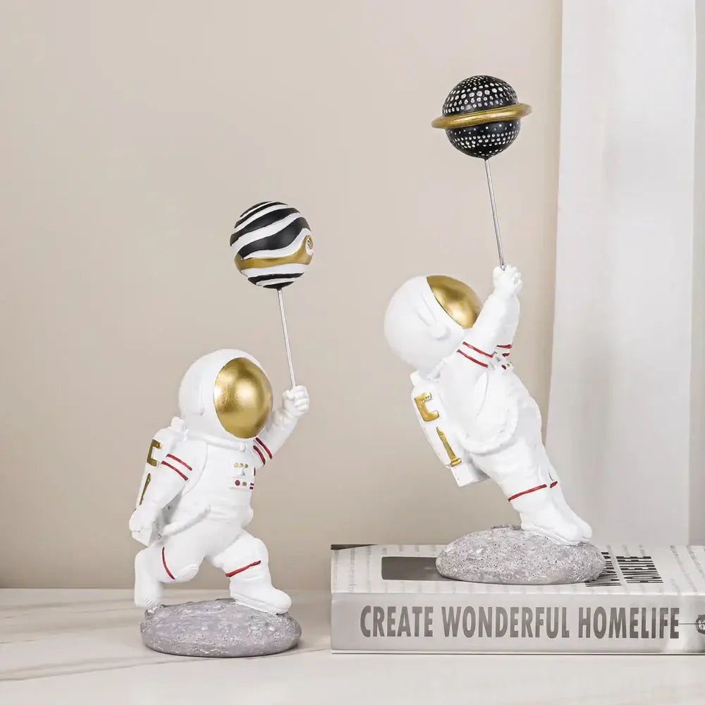 White and gold astronauts figurines with balloons living room decor