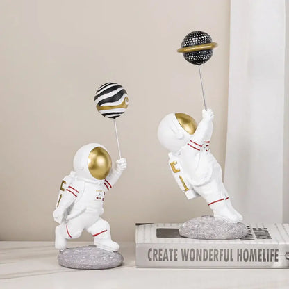 White and gold astronauts figurines with balloons living room decor