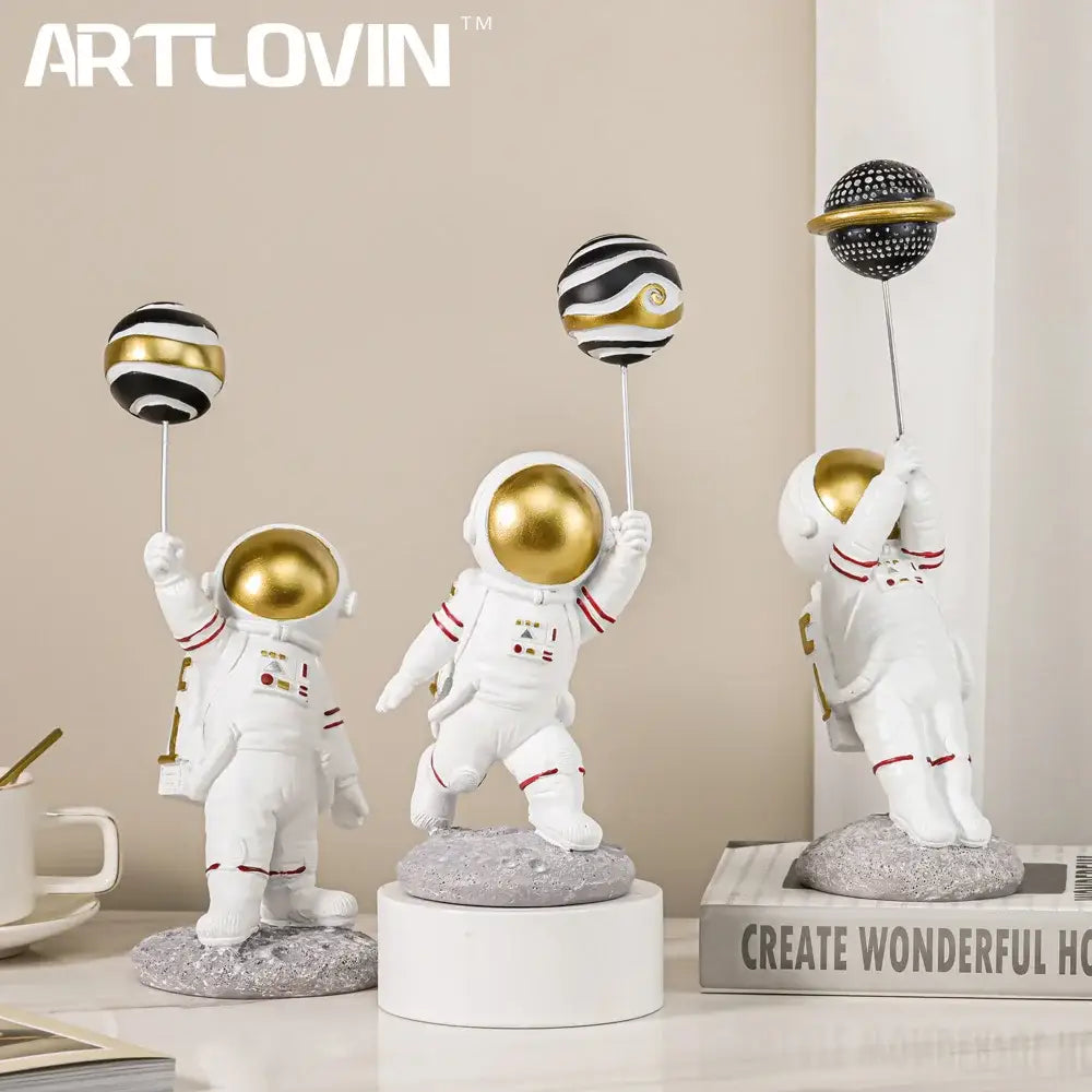 White and gold astronauts figurines with balloons living room decor
