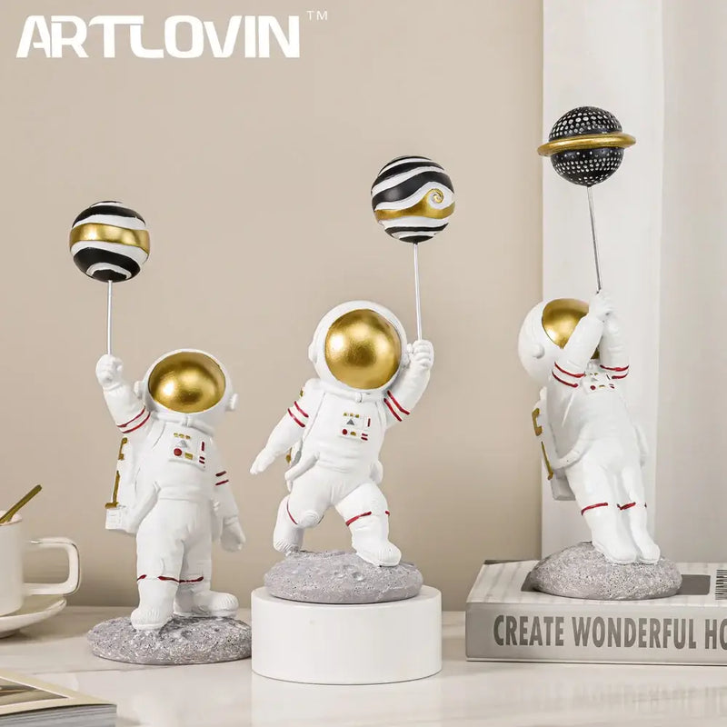 White and gold astronauts figurines with balloons living room decor