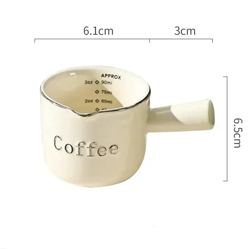 White ceramic espresso measuring cup and milk pitcher kitchen decor