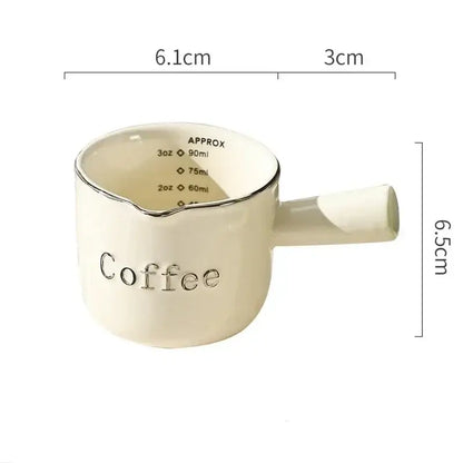White ceramic espresso measuring cup and milk pitcher kitchen decor