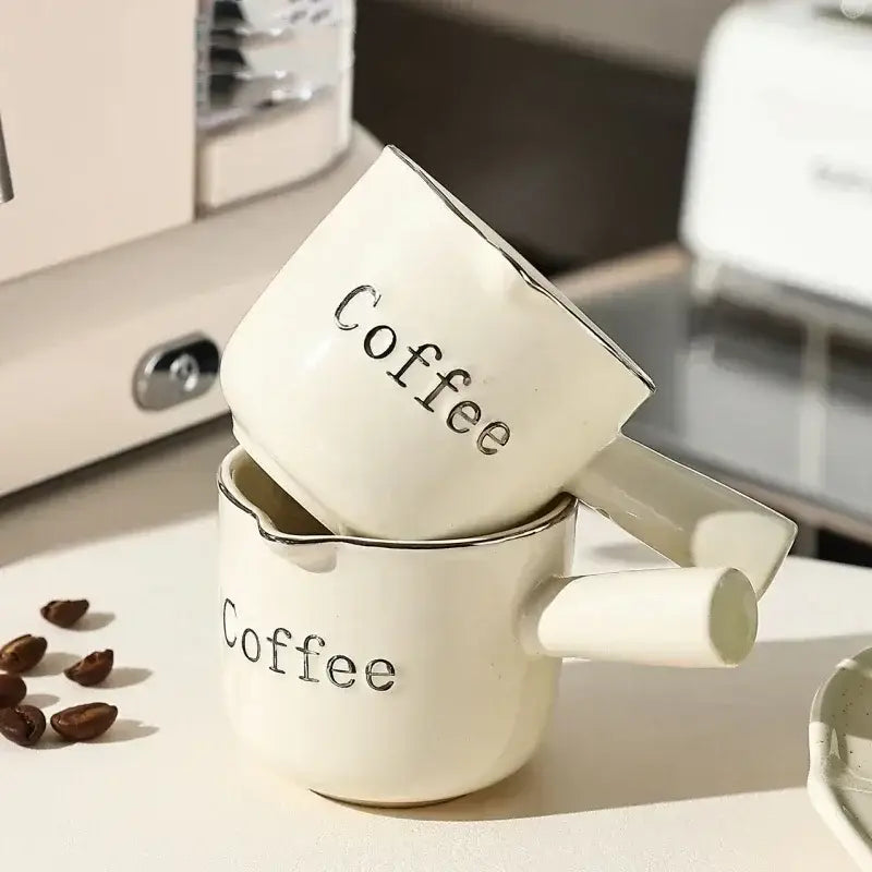 White ceramic espresso measuring cup and milk pitcher kitchen decor