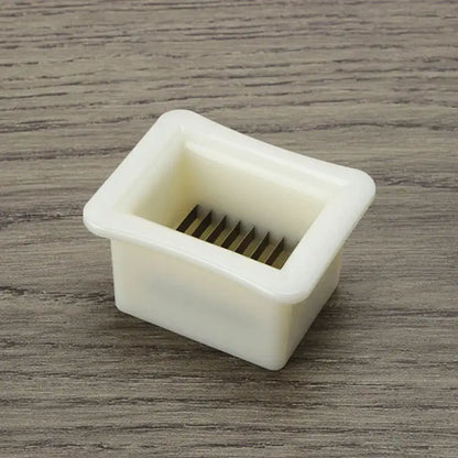 White plastic green bean slicer with metal blades kitchen shredder