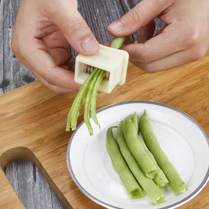 White plastic green bean slicer with metal blades kitchen shredder